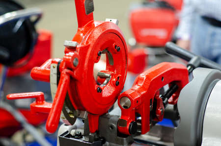 Close-up of portable compact pipe threading machine.