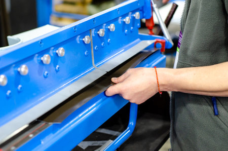 The operation of hydraulic bending machine with technician.の写真素材