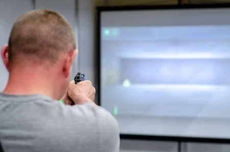 Man shooting in a virtual shooting galleryの写真素材