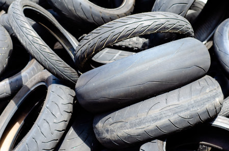 Worn motorcycle tires in a junkyardの写真素材