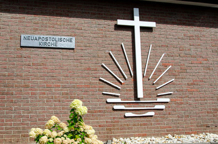 Warstein, Germany - August 15, 2021: Emblem of the New Apostolic Church (Neuapostolischen Kirche) on a brick wallのeditorial素材