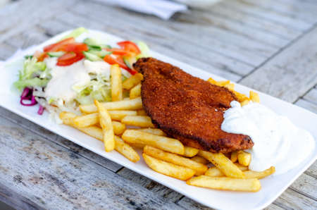 Schnitzel with french fries and saladの写真素材