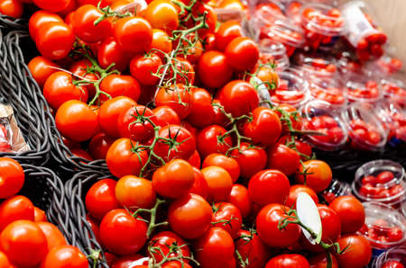Different varieties of tomatoes in the store for saleの写真素材