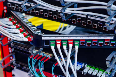 Wires are in rack with servers and internet equipmentの写真素材