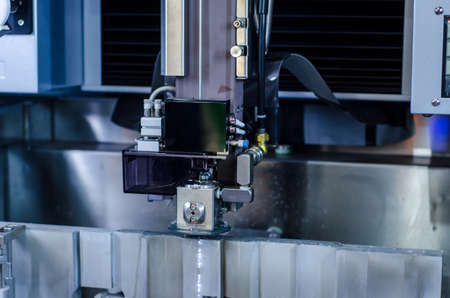 Cutting the metal of the EDM machineの写真素材