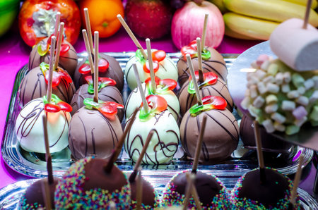 Apples covered in chocolate for sale at the fair.