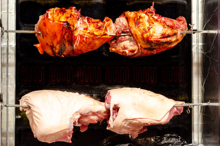 Roasted pork meat on spit grilled over fire