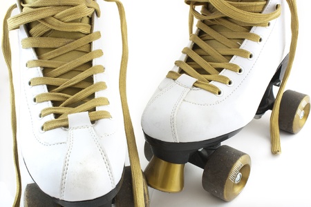 a pair of white and gold rollerskates