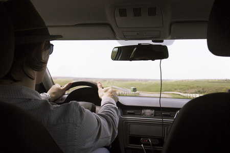 video recorder driving a car on highway. hidden camera. The man in the hat drives the car.の写真素材