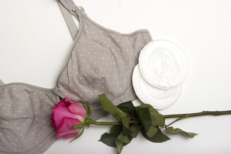 Nursing bra for mothers and Silicon nipples. moms bra with new disposable breast pad. Prevents the flow of milk on the clothes, it is convenient to unfasten the cups for feeding the baby. A rosebud of pink color in the language of flowers means pride and の写真素材