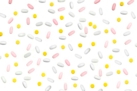 a lot of multicolored pills and capsules on the white backgroundの写真素材