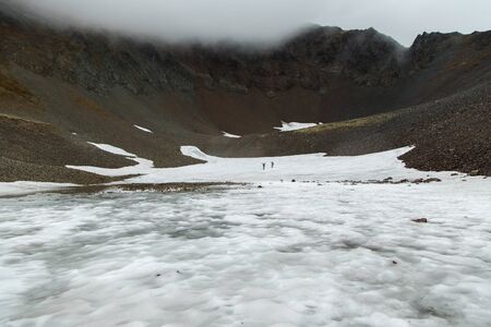 Snowy circus of volcano, fog in Vachkazhetz, Kamchatka peninsula, Russia.