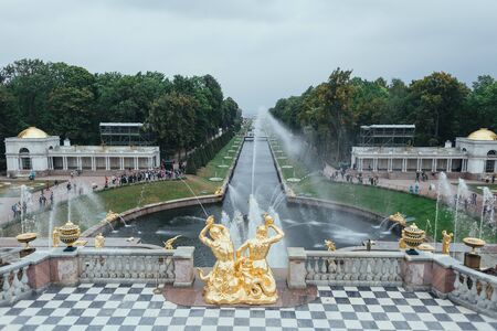 Saint Petersburg, Russia - 18 September 2015 - Neptune fountaine in the upper garden in Peterhof park in rainy day.のeditorial素材