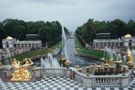 Saint Petersburg, Russia - 18 September 2015 - Neptune fountaine in the upper garden in Peterhof park in rainy day.のeditorial素材