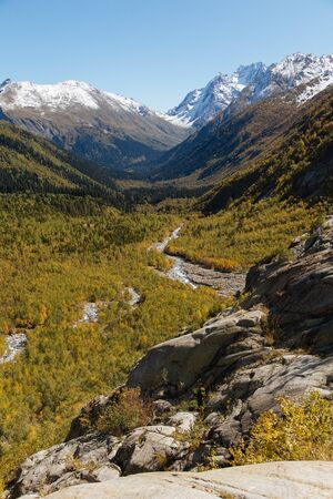 Dombay mountains, trekking in national park to the Alibek waterfall and glacier, beautiful autumn landscapeの写真素材