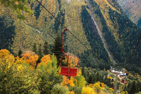 Old chairlift cableway in Dombay ski resort from the Mount Mussa Achitara in autumn season, beautiful mountains landscape, Caucasus, Russiaの写真素材