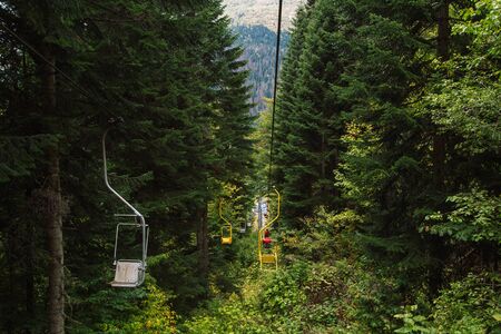 Dombay ski resort from the cableway chairelift, beautiful forest landscape, Caucasus, Russiaの写真素材