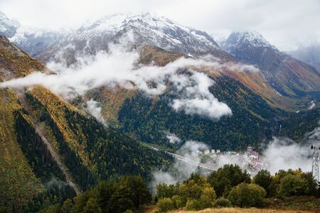 Fog in the mountains, scenic view from the Mount Mussa Achitara in Dombay ski resort in autumn...