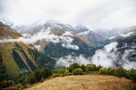 Fog in the mountains, scenic view from the Mount Mussa Achitara in Dombay ski resort in autumn season, Caucasus, Russiaの写真素材