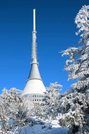 The snow-covered ridge of JeÅ¡tÄd is dominated by a white tower with a transmitter Jested.のeditorial素材