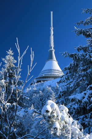 The snow-covered ridge of JeÅ¡tÄd is dominated by a white tower with a transmitter Jested.のeditorial素材