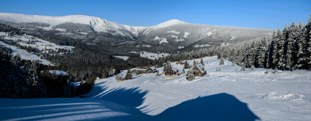 Snow covered mountain valley Mulda with background of Krkonose ridge and dominant Snezka mountainのeditorial素材