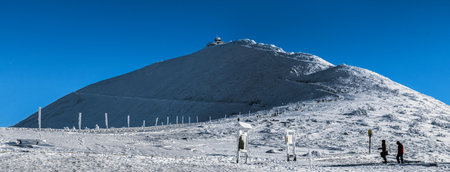 Snezka moumtain in winter robe with marked path to the peak, where you can see the High Mountain Meteorological Observatory. Winter Time in Krkonose National Park - the highest point in the Czech Republic is Snezka.のeditorial素材