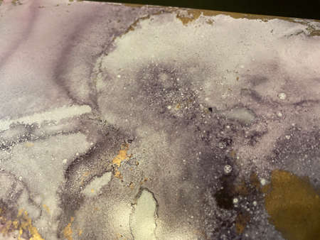 Abstract pink-violet background with gold. Beautiful smudges and stains made with alcohol ink and...