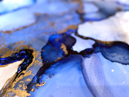 Abstract blue art background with beautiful smudges and stains made with alcohol ink and gold pigment. Fragment of art with blue fluid texture resembles watercolor or aquarelle painting.の写真素材