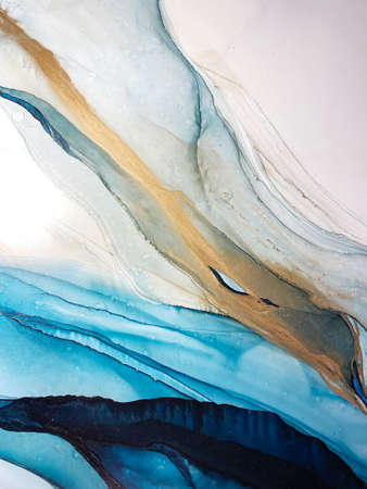 Abstract blue-green background with gold, beautiful smudges and stains made with alcohol ink and...