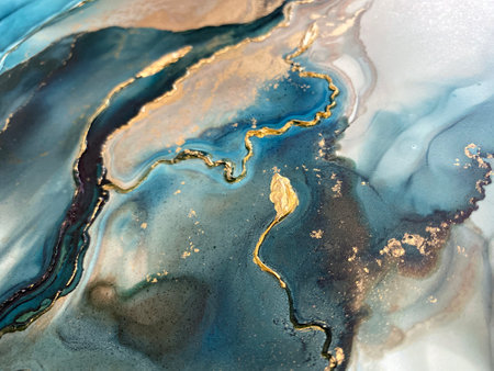Abstract blue-green background with gold and beautiful smudges made with alcohol ink and golden acrylic. Fragment of art with turquoise texture resembles watercolor or aquarelle painting.の写真素材
