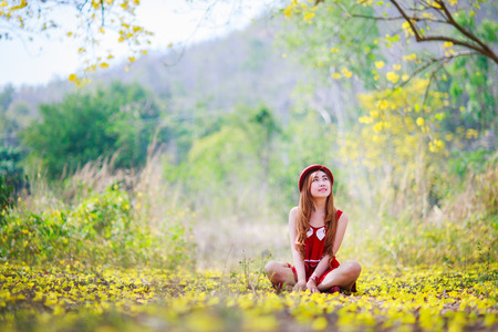 Portrait of a beautiful  girl among yellow flowers in the nature,thailand,asia.の写真素材