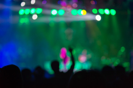 Blurred background : Bokeh lighting in outdoor concert with cheering audience, hands upの写真素材