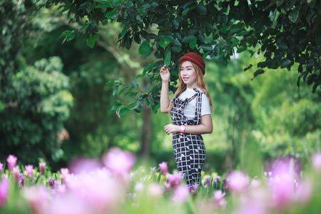 Beautiful girl holding bouquet flowers .Portrait in nature field.の写真素材