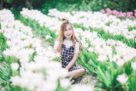 Beautiful girl holding bouquet flowers .Portrait in nature field.の写真素材