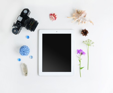 Tablet, camera, flowers, crystal and seashells on white background. Flat lay. Mock up for art workの写真素材