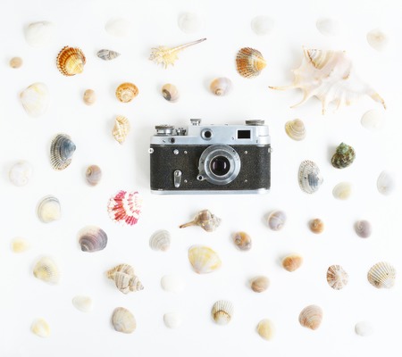 Retro camera with seashells on white background. Vintage postcardの写真素材