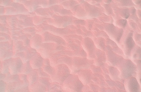Beach pink sand background. Close up texture with unusual sea sandの写真素材