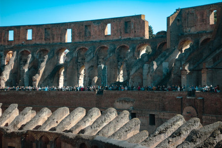 Inside view of the iconic Roman Colosseum, featuring its massive stone walls and ancient arches....