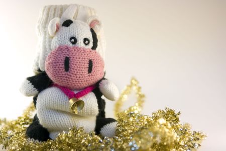 Mitten cow sitting on tinselsの写真素材