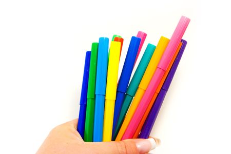 Multi colored highlighters in female hand on white backgroundの写真素材