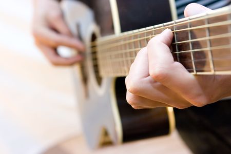 Young artist playing guitar on white background