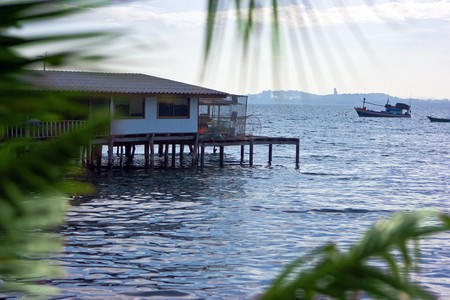 Fishing village house standing on piles in the seaの写真素材