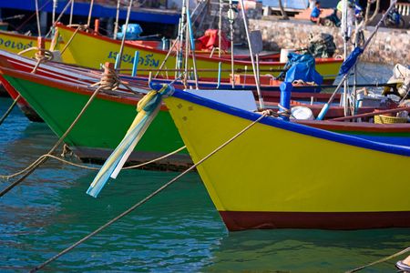Thai fishing boats anchored at the pierの写真素材