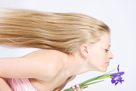 Beautiful fresh blond lady with long hair and irisの写真素材