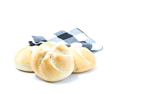 Mini crusty star format bread isolated in white background with a checked blue dish clothの写真素材