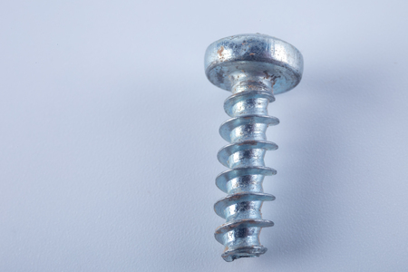 Macro rusty steel screw isolated on white backgroundの写真素材