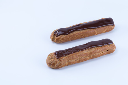 Two delicious parallel french chocolate eclairs  isolated in white backgroundの写真素材
