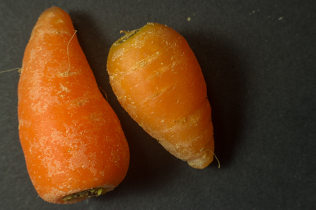 Macro of baby carrots isolated on dark background
