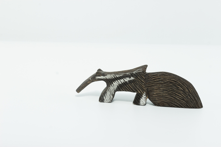 Anteater - tamanduá bandeira - carved on wood isolated in white backgroundの写真素材